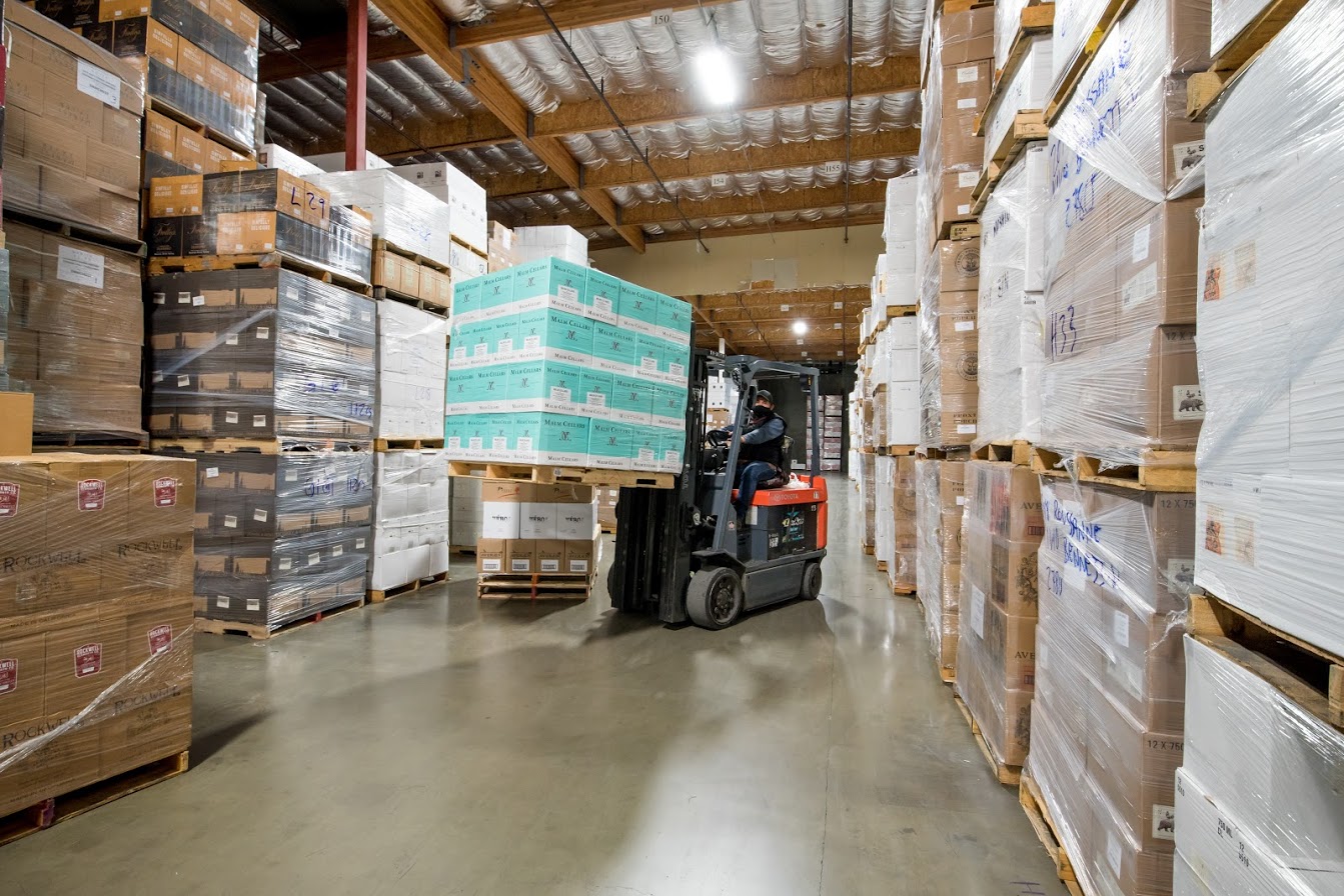 Forklift carrying boxes in warehouse
