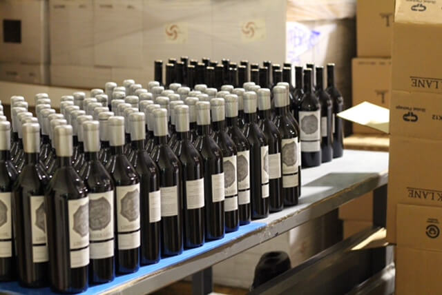 Wine bottles ready to be packaged into cases.
